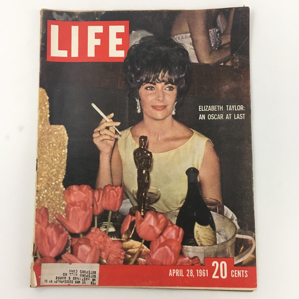 Vintage Life Magazine cover, April 28, 1961, featuring Elizabeth Taylor celebrating her Oscar win with flowers and a drink.