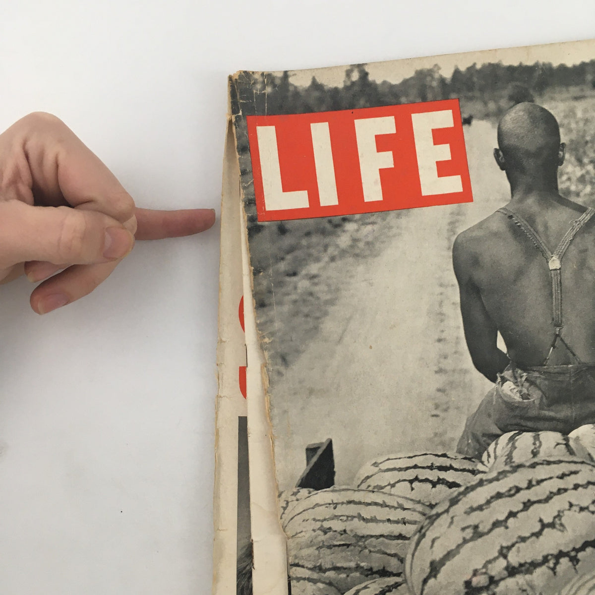 Side view of the VTG Life Magazine August 9 1937, highlighting the iconic LIFE logo and the photograph of a man transporting watermelons.