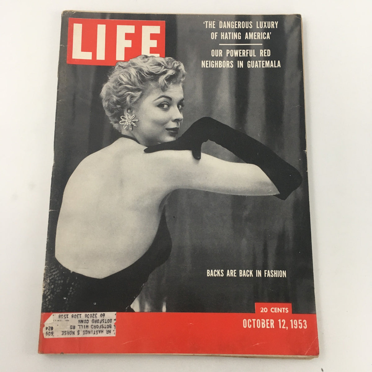 Vintage Life Magazine cover from October 12, 1953 featuring the article 'Backs Are Back in Fashion'. The cover showcases a glamorous model in a black dress with an elegant hairstyle, emphasizing 1950s fashion trends.
