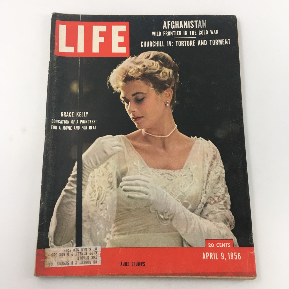 Vintage Life Magazine cover from April 9, 1956, featuring Grace Kelly with the title 'Education of a Princess.' The magazine illustrates Kelly's transition from Hollywood star to royal, complete with elegant attire and pearls, centering on her unique story.