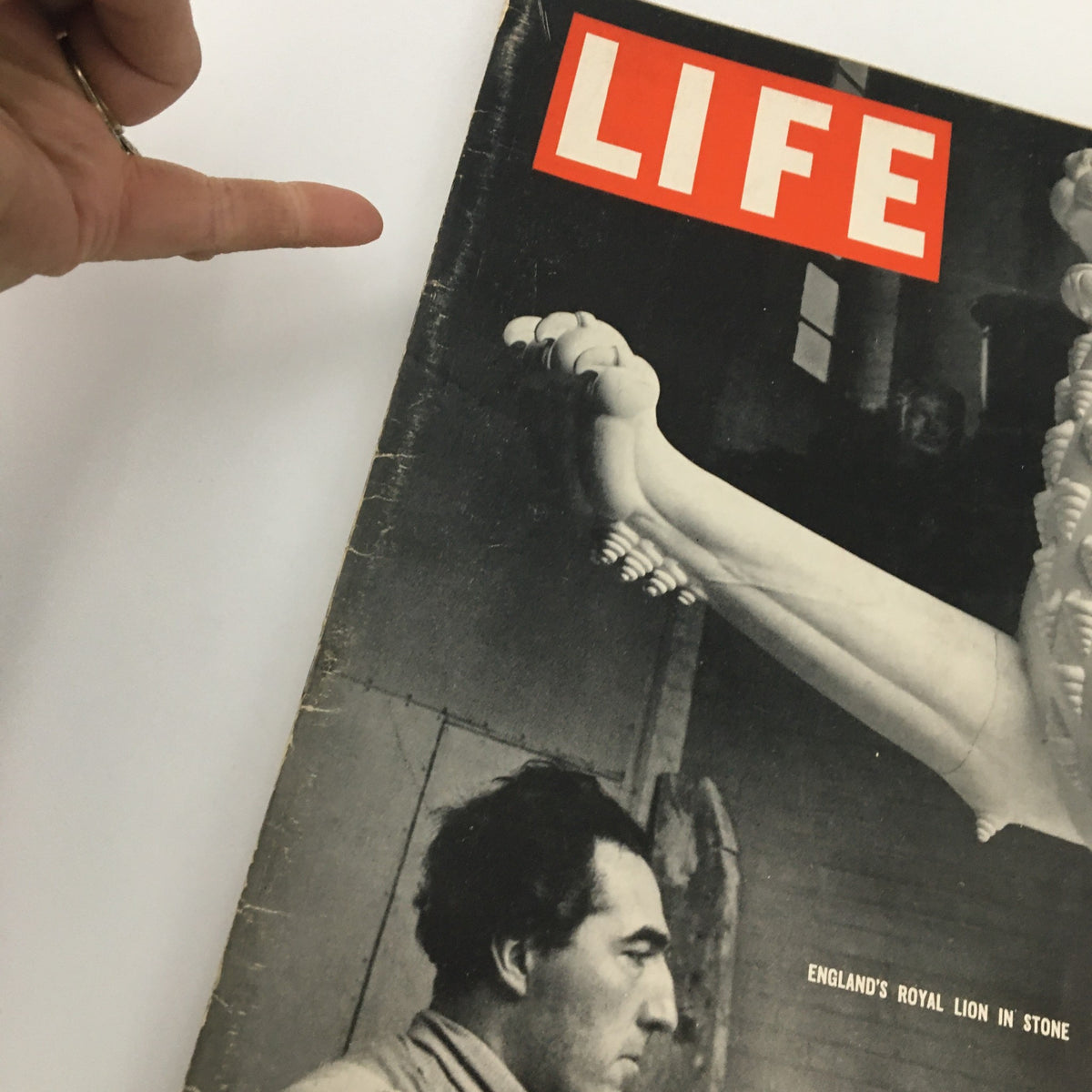 Close-up of VTG Life Magazine January 25, 1937 cover showing a sculptor detailing a lion statue with a hand pointing at the cover.
