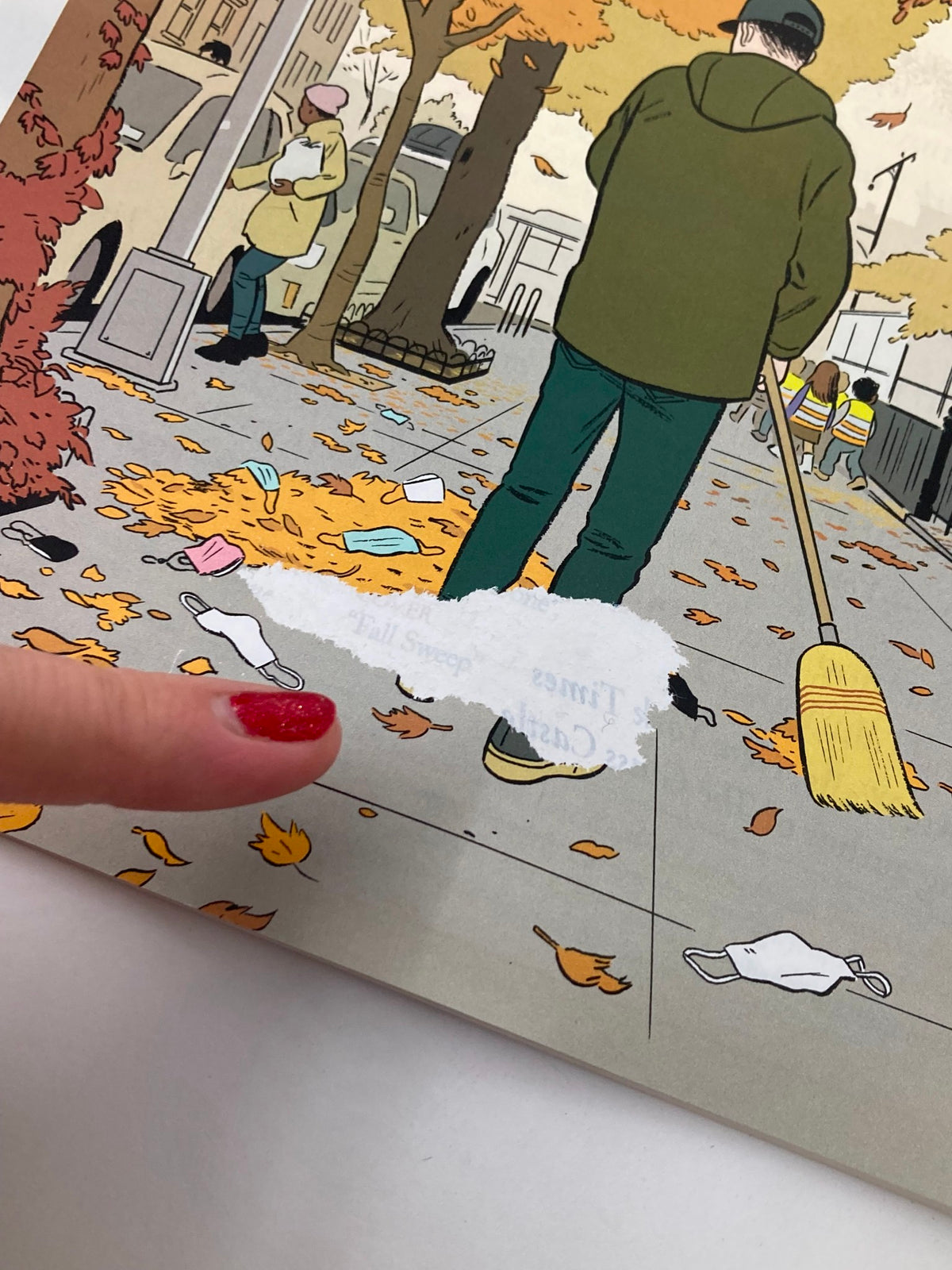 Close-up of The New Yorker Full Magazine November 7 2022 Fall Sweep by Adrian Tomine, showing autumn debris and a person's finger pointing at the page.