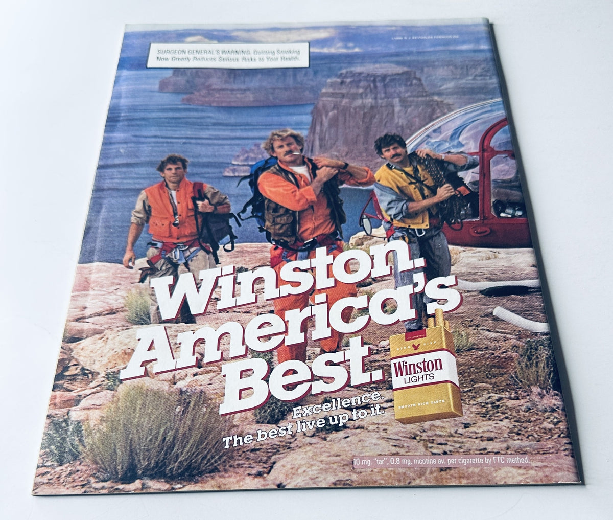 Advertisement page for Winston cigarettes from Sports Illustrated Magazine January 6, 1986, featuring three men in outdoor gear promoting the brand.