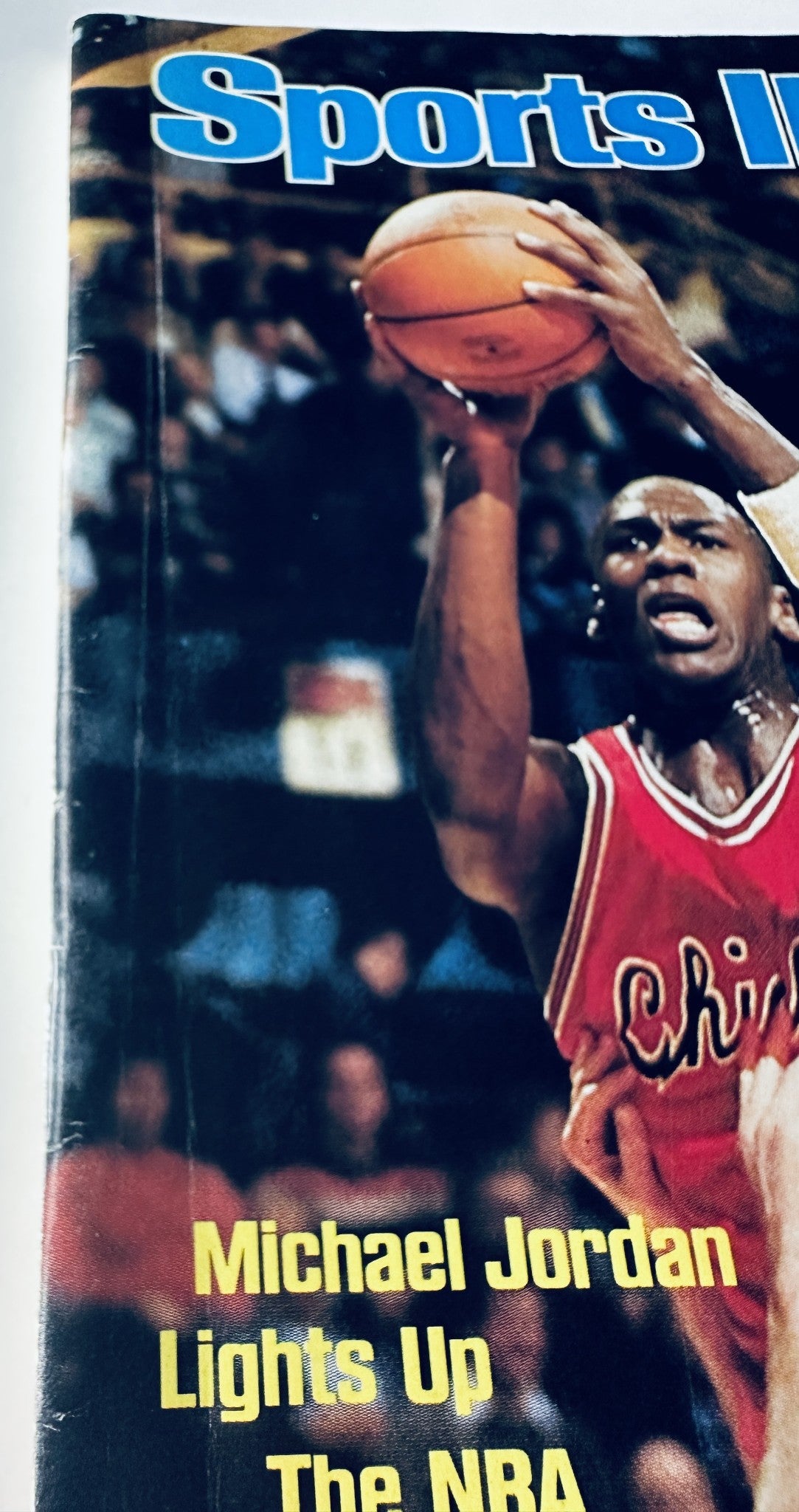 Close-up of the Sports Illustrated Magazine cover from December 10, 1984 featuring Michael Jordan. The text 'Michael Jordan Lights Up The NBA' highlights his significant role in transforming the game during his rookie year.