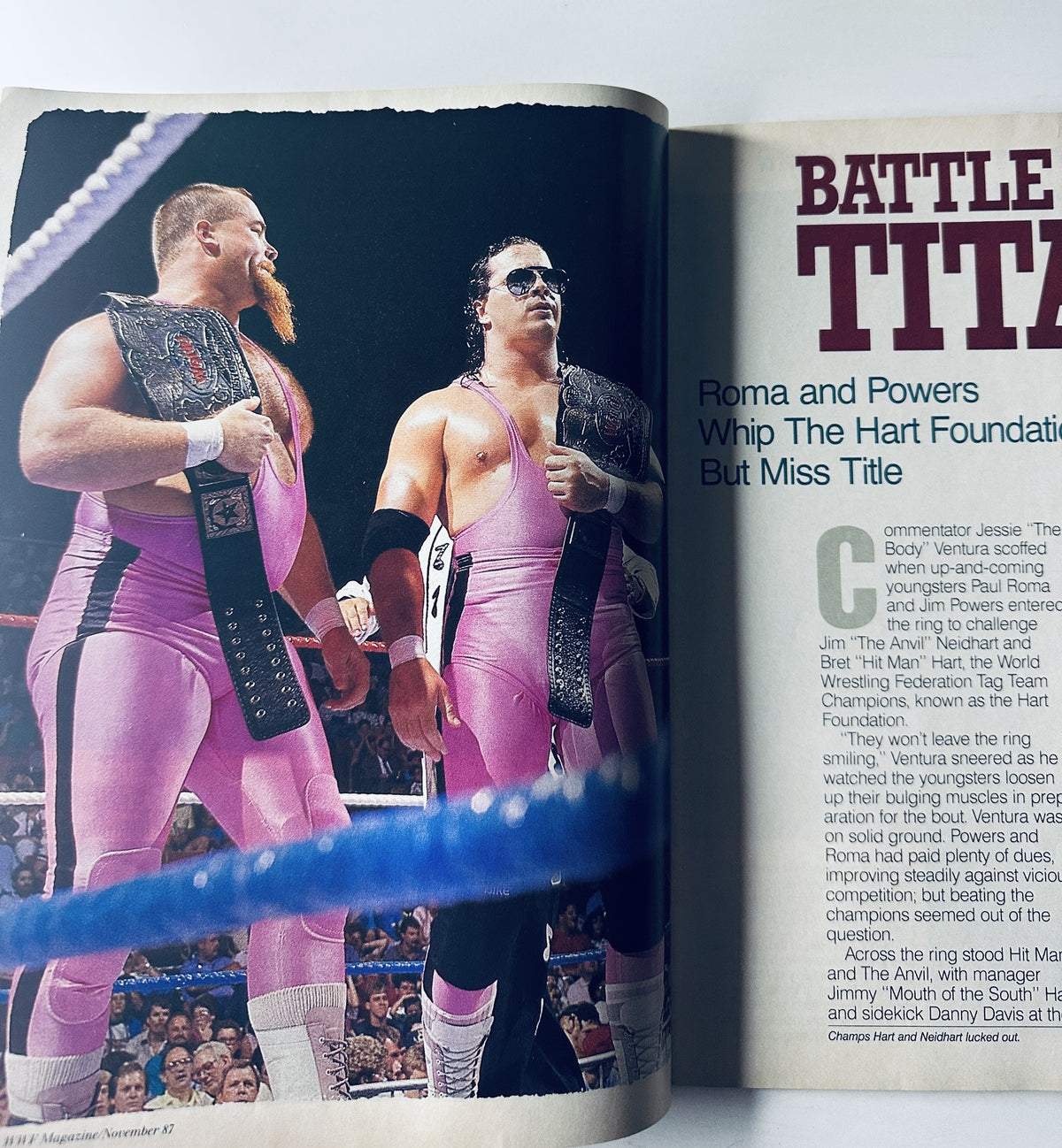 Photo from WWF Magazine November 1987 depicting tag team wrestlers Roma and Powers in pink attire during a wrestling match.