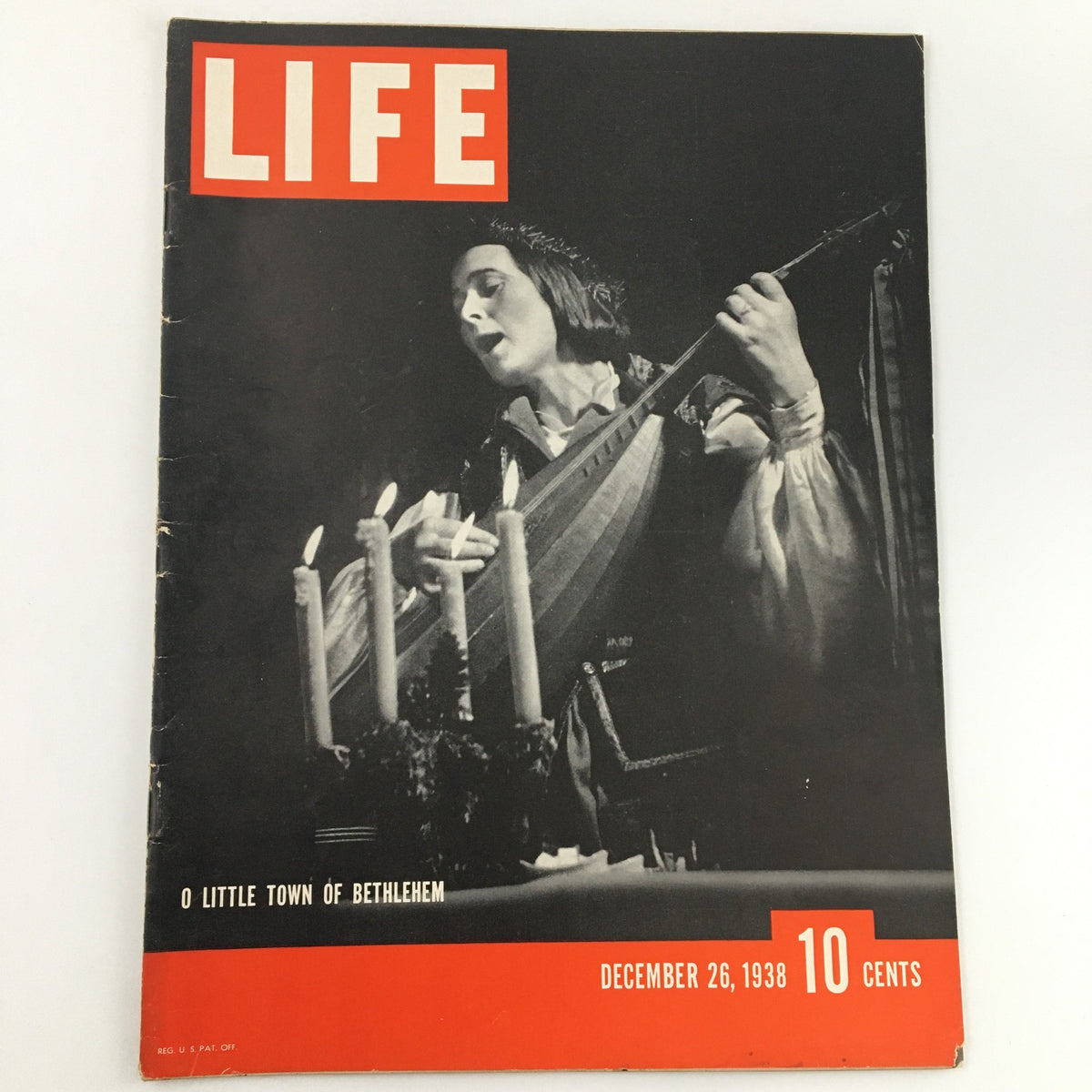 Cover of Life Magazine December 26, 1938 featuring 'O Little Town Of Bethlehem' with a singer holding a lute next to candles.