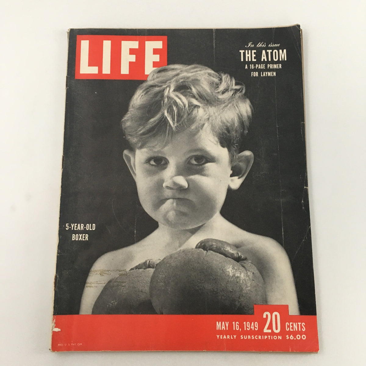 Cover of VTG Life Magazine dated May 16, 1949 featuring a 5-year-old boxer gripping boxing gloves. The magazine emphasizes 'The Atom' and showcases iconic post-war imagery. Ideal for vintage magazine collectors.