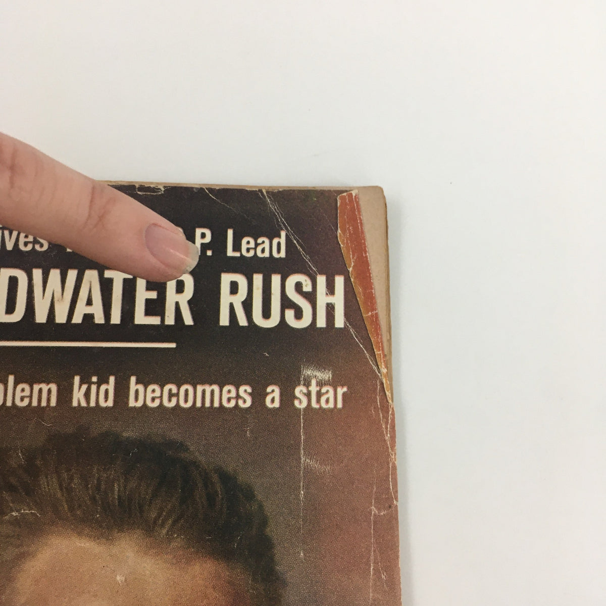 Close-up view of the top portion of the vintage Life Magazine cover from July 12, 1963. The title displays 'The Goldwater Rush' above Steve McQueen's phrase 'Problem Kid Becomes A Star' with visible wear and tear.