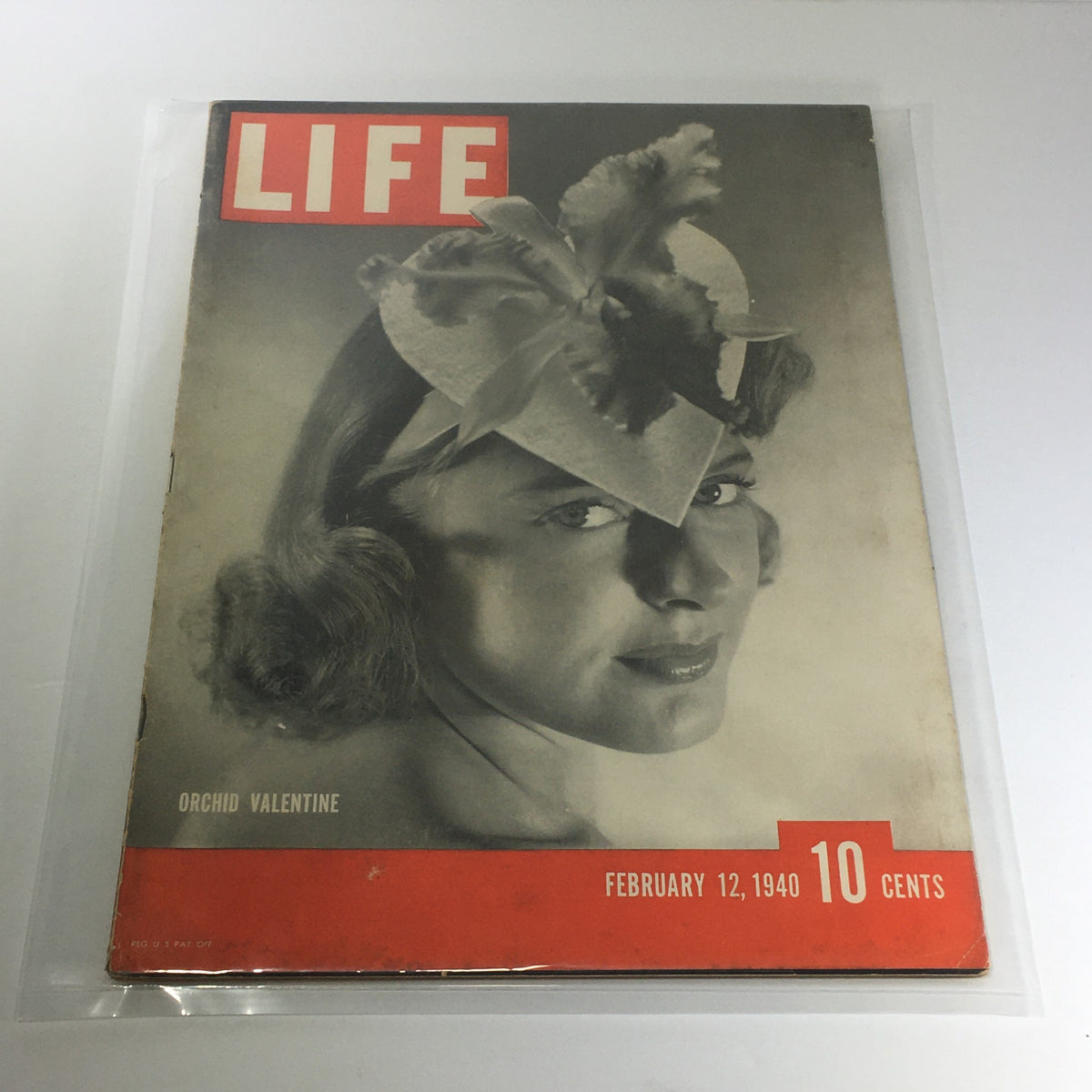 Vintage Life Magazine: February 12, 1940 - Orchid Valentine cover featuring a glamorous woman with a floral hat, showcasing classic design and typography of the era.
