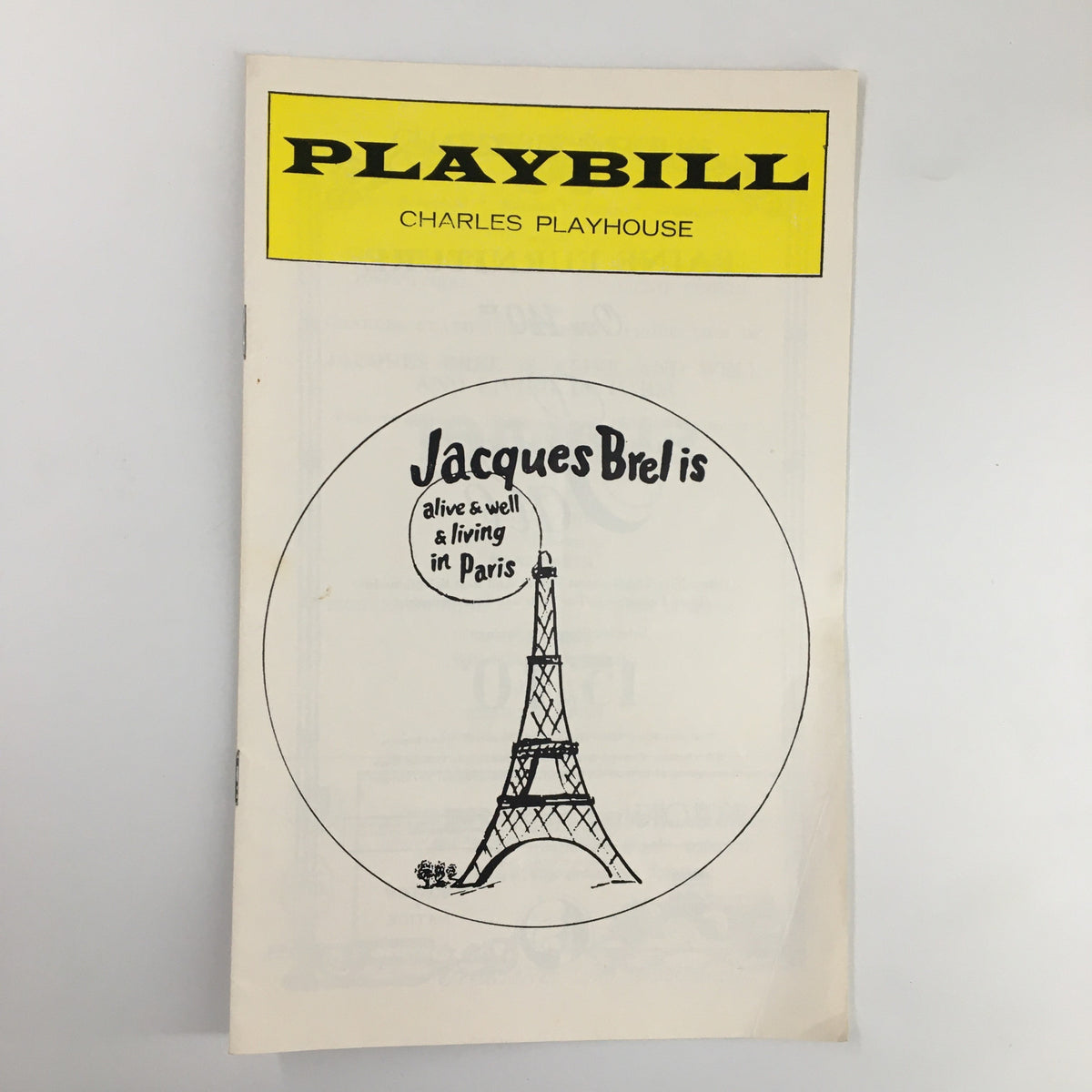 1975 Playbill for Jacques Brel is Alive & Well at Charles Playhouse, featuring an iconic Eiffel Tower illustration and vintage design.