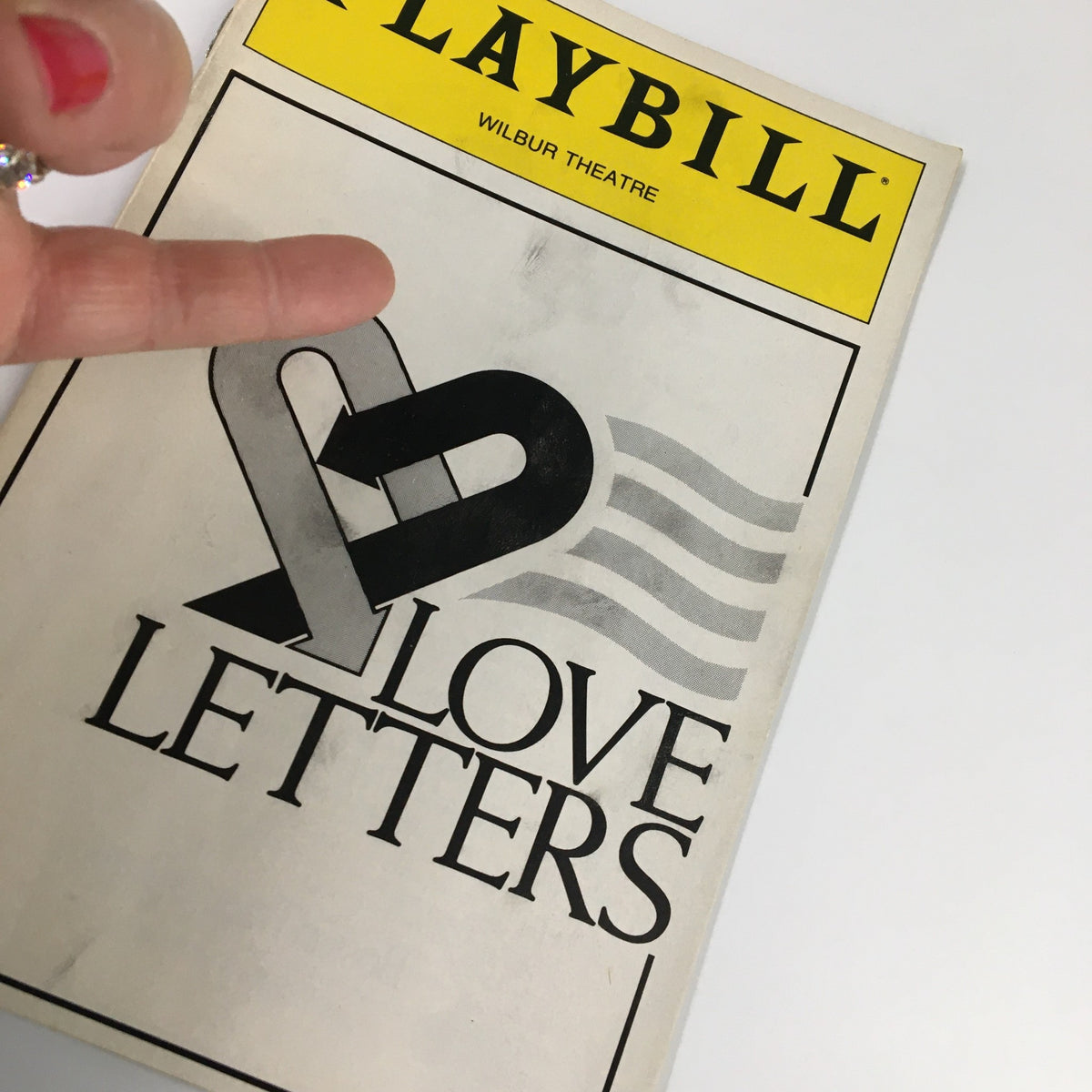 Close-up view of the 1990 Playbill from Wilbur Theatre for Love Letters, highlighting the cover design with a heart graphic.