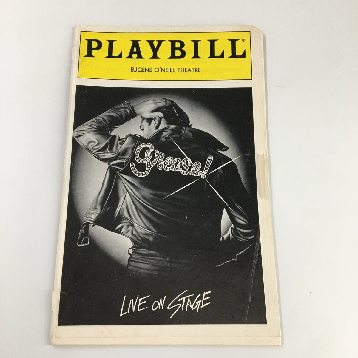 1994 Playbill for 'Grease' at the Eugene O'Neill Theatre featuring a black and white cover image of a man in a leather jacket with the title 'Grease!' prominently displayed. Designed for live stage performances.