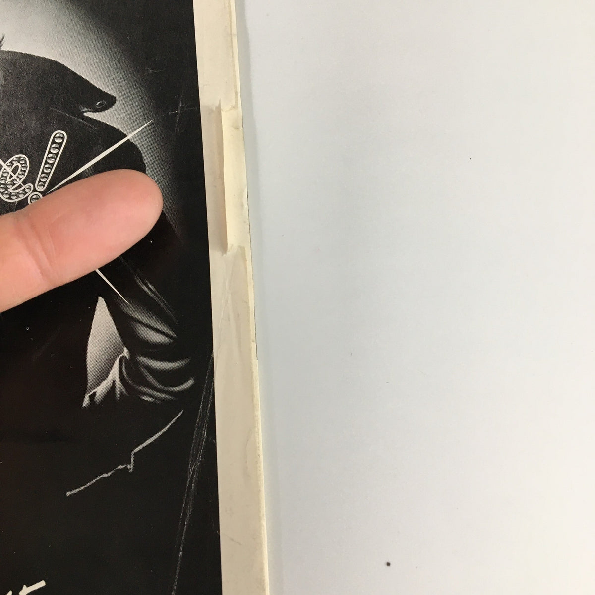 Close-up of the 1994 Playbill for 'Grease' at the Eugene O'Neill Theatre, showcasing details of the cover including the title 'Grease!' and a part of a man's leather jacket.