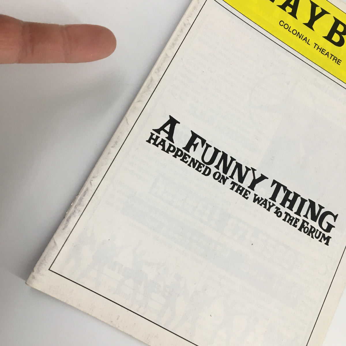 Close-up of the 1987 Playbill from the Colonial Theatre focusing on the title 'A Funny Thing Happened on the Way to the Forum'.