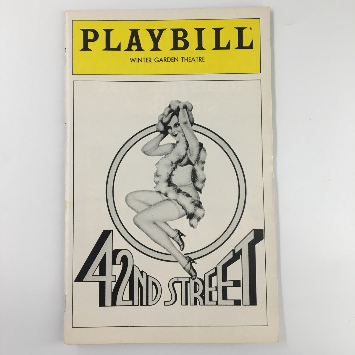1980 Playbill for '42nd Street' featuring a vintage design with a dancer in a feathered outfit, representing the musical at the Winter Garden Theatre.