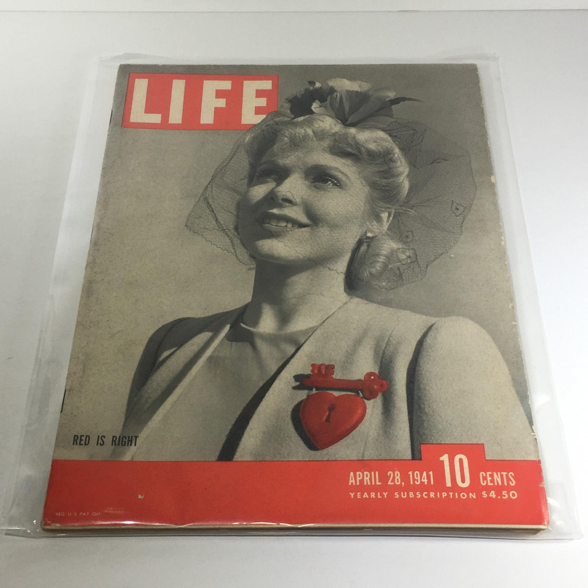 Vintage Life Magazine Cover - April 28, 1941 featuring the title 'Red Is Right' with a smiling woman wearing a hat and jewelry, showcasing its classic design and subscription details.