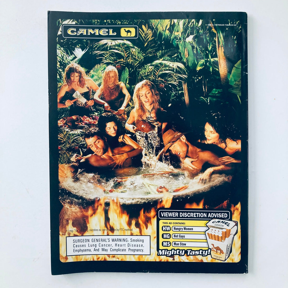Back cover of Playboy Magazine July 1999 with an advertisement for Camel cigarettes featuring a beach scene with attractive individuals.