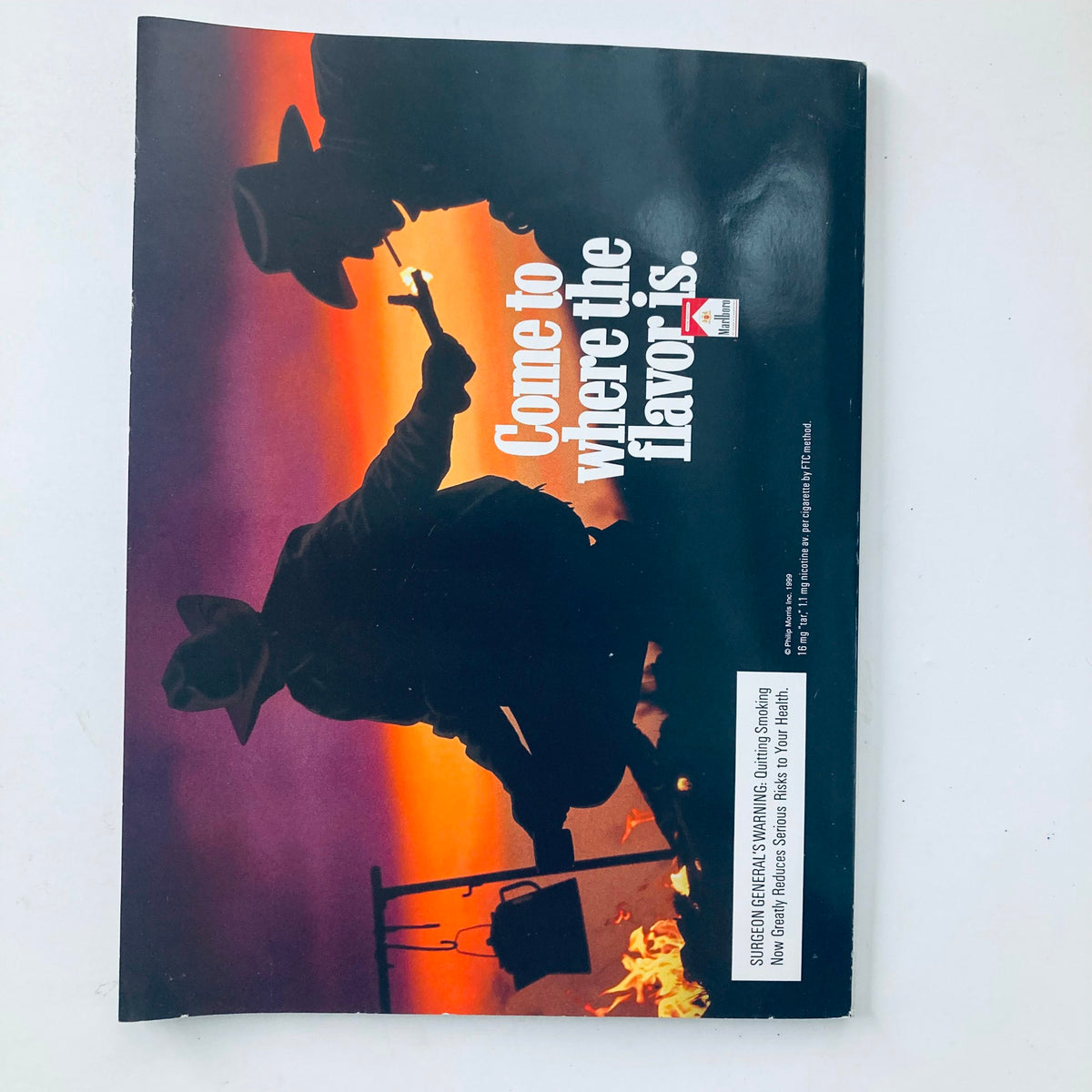 Back cover of Playboy Magazine April 1999 with a vintage advertisement, depicting cowboy silhouettes and the tagline 'Come to where the flavor is.'