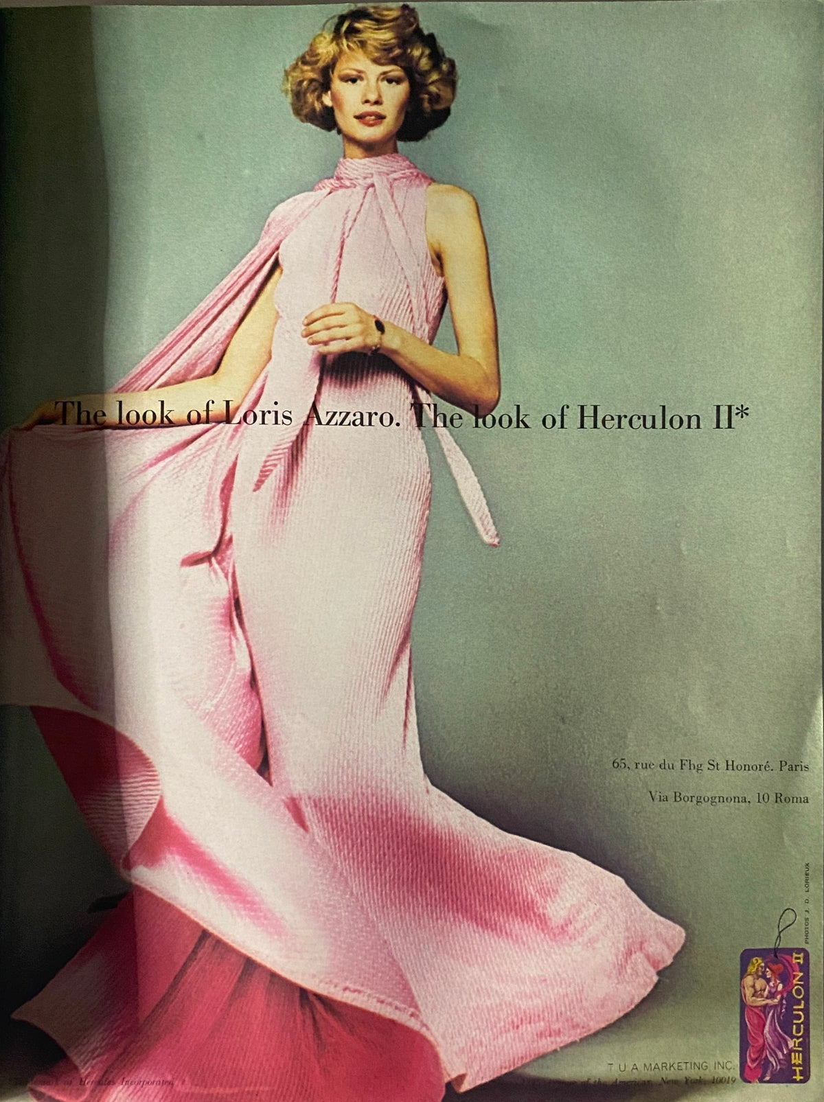 Advertisement page from Vogue Paris Magazine August 1973 featuring a model in a pink dress by Loris Azzaro, demonstrating the luxurious styles of the era.
