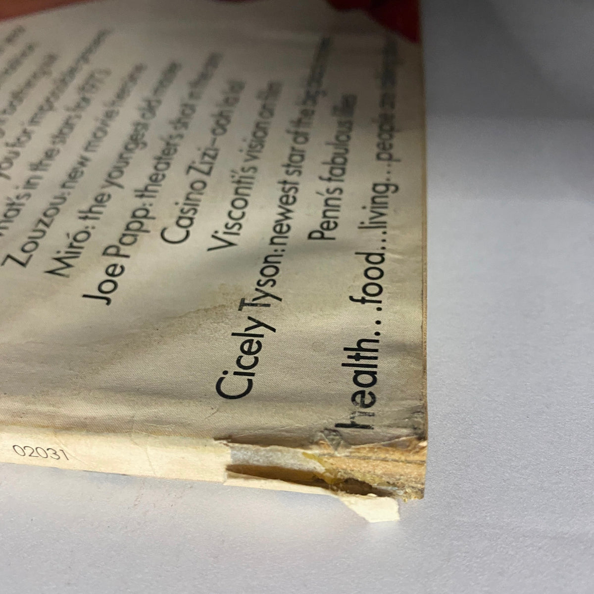 Close-up of the spine of Vogue Magazine December 1972 with signs of age, highlighting its vintage status.