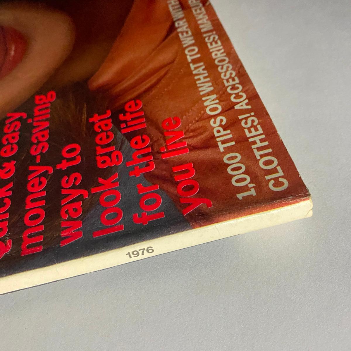 Detail of the 1976 Vogue Fashion Guide Magazine showing the publication year and highlights of the issue, featuring tips on fashion and styling.