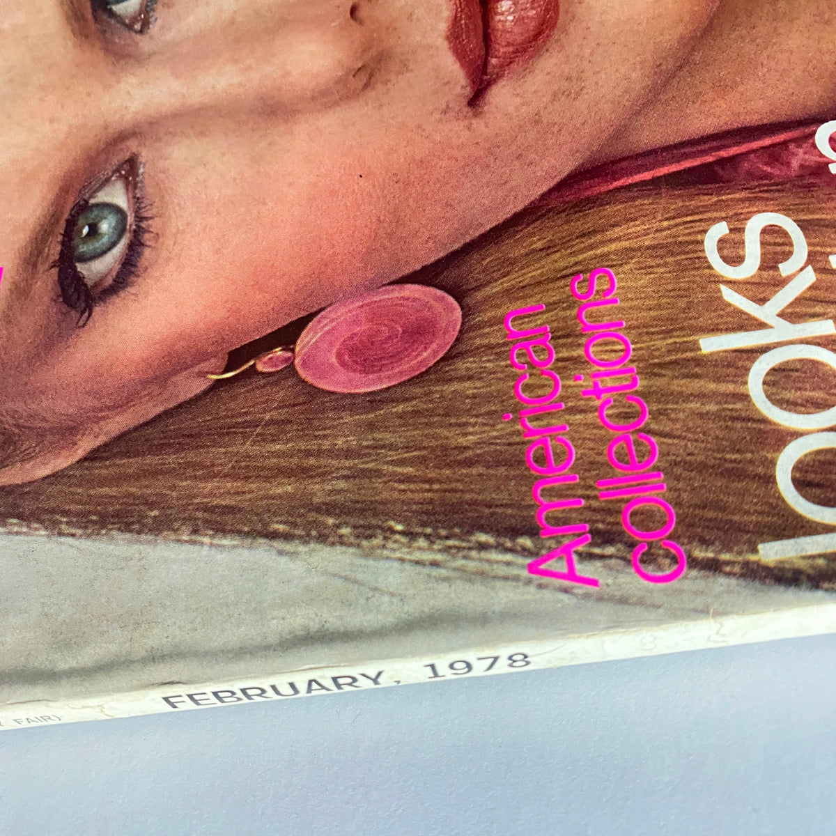 Close-up view of the Vogue Magazine February 1978 cover, emphasizing Patti Hansen's captivating eyes and stylish earrings, reflecting the 1970s fashion era.