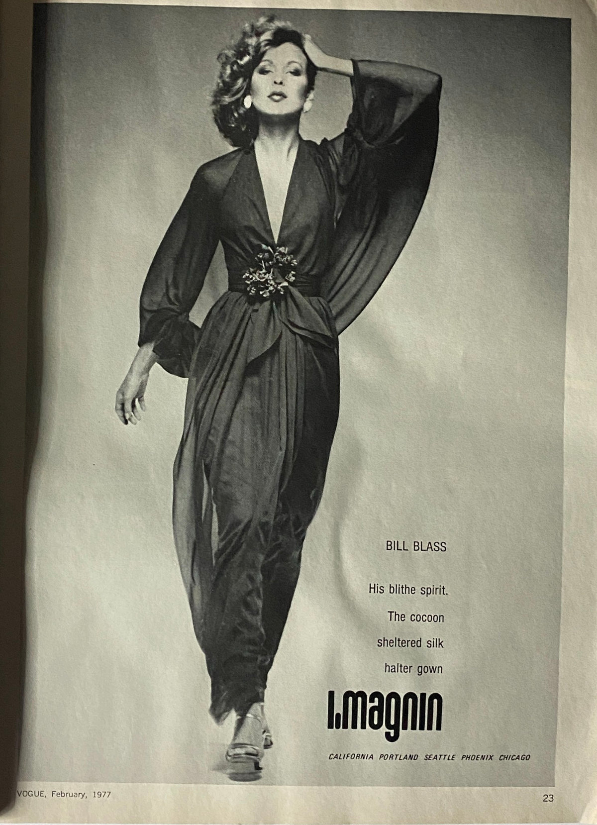 A fashion model in Vogue Magazine February 1977 wearing a Bill Blass gown, epitomizing the glamorous style of the 1970s.