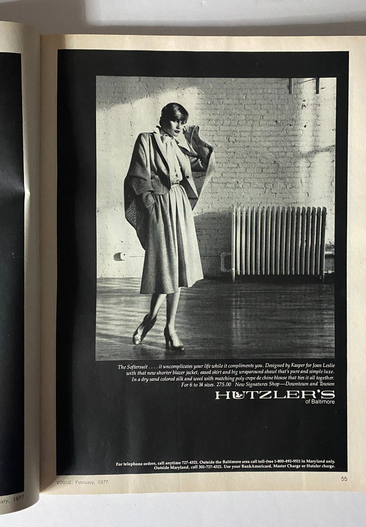 Black and white advertisement for Hutzler's, displaying a sophisticated women's outfit, from Vogue Magazine February 1977.