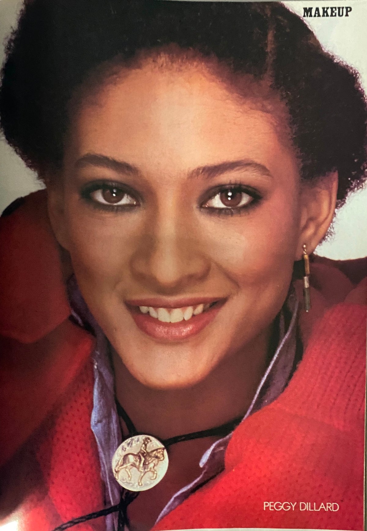 Vogue Magazine Fall/Winter 1978-1979 image depicting Peggy Dillard, an iconic model, showcasing makeup and fashion from the late 1970s with a charming smile and fashionable attire.