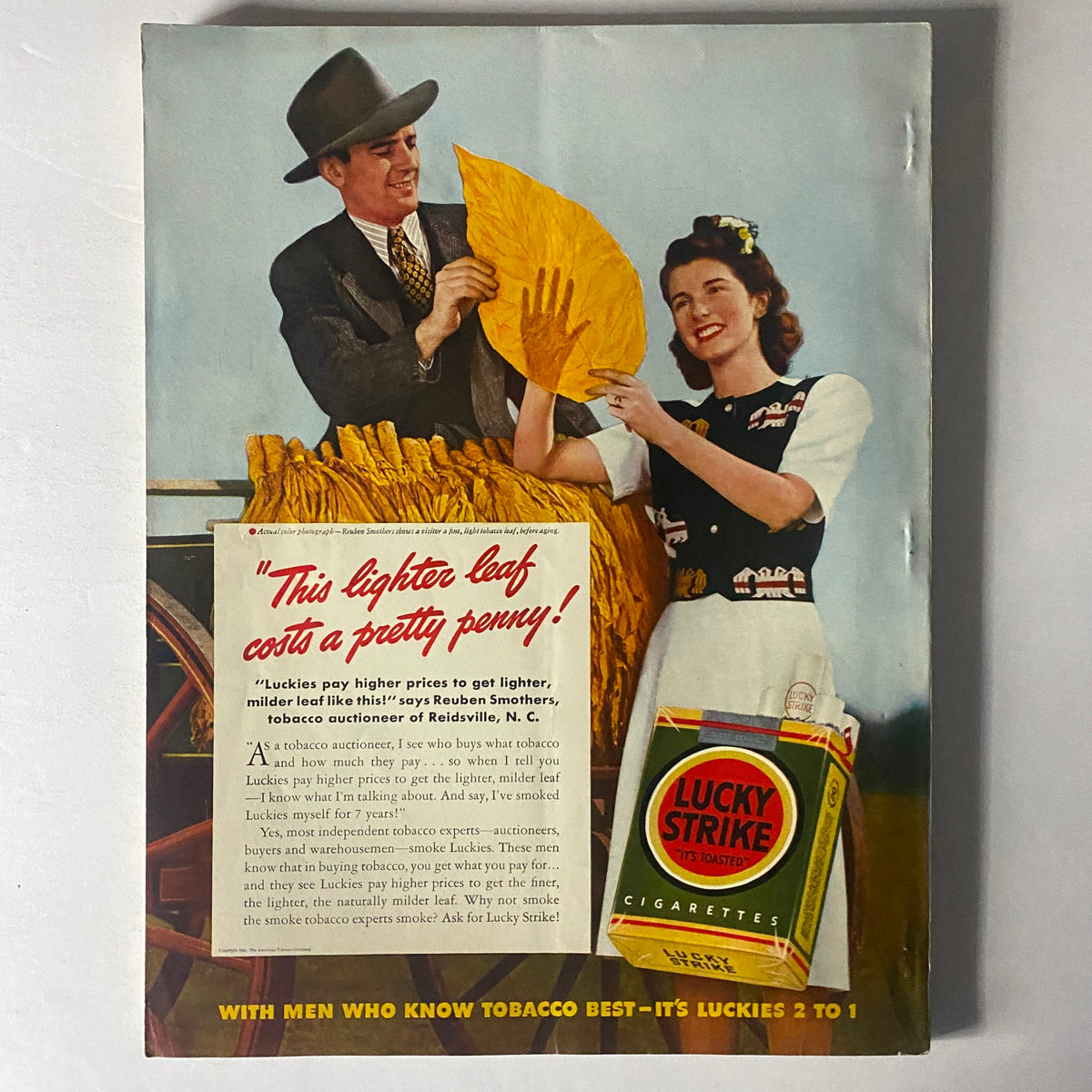 Advertisement for Lucky Strike cigarettes, featuring two individuals in vintage attire, included in Mademoiselle Magazine July 1941 Summer Beauty Issue.