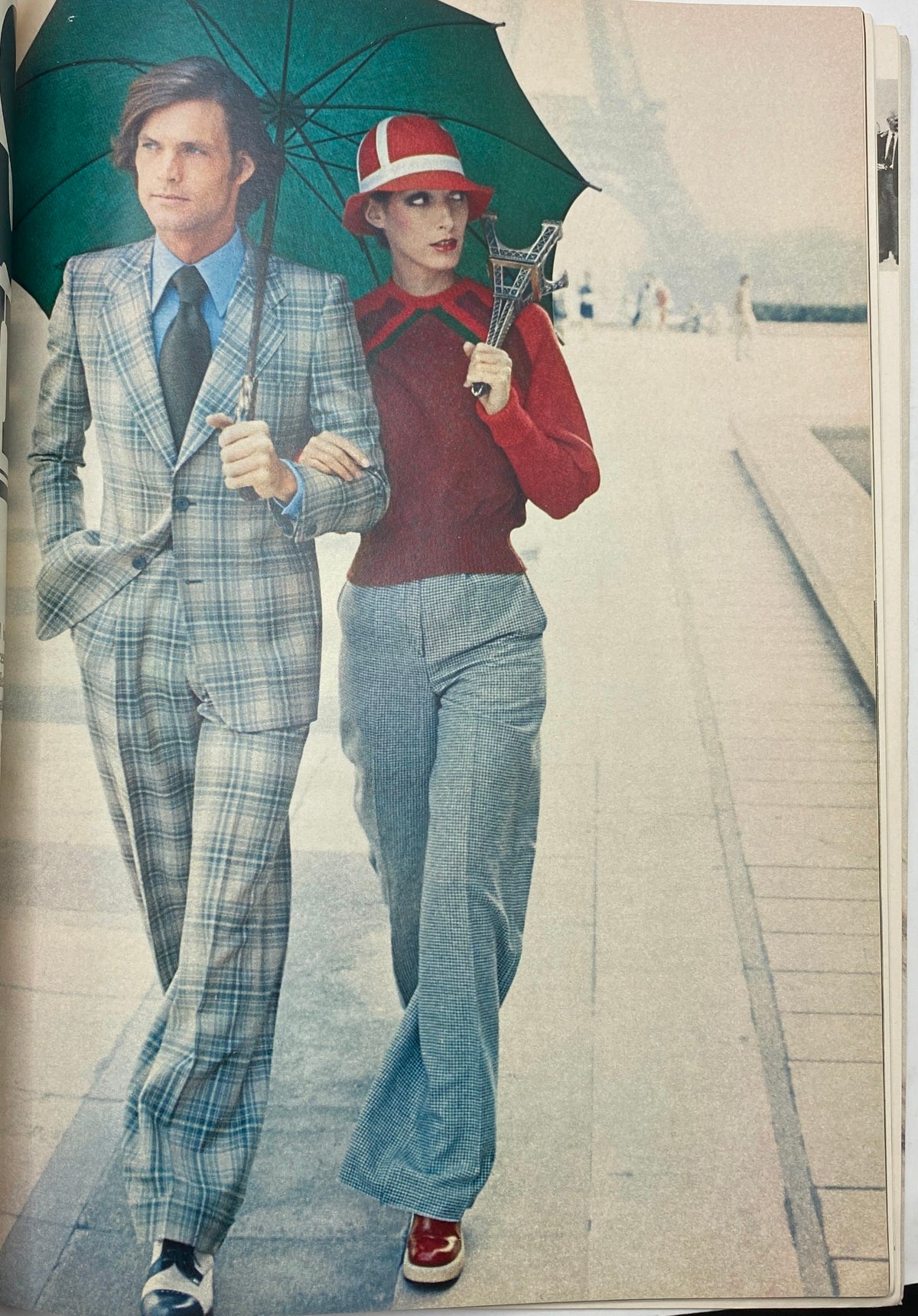 Editorial fashion spread from Esquire Magazine February 1973 showing a man and woman walking under an umbrella, showcasing 1970s fashion.