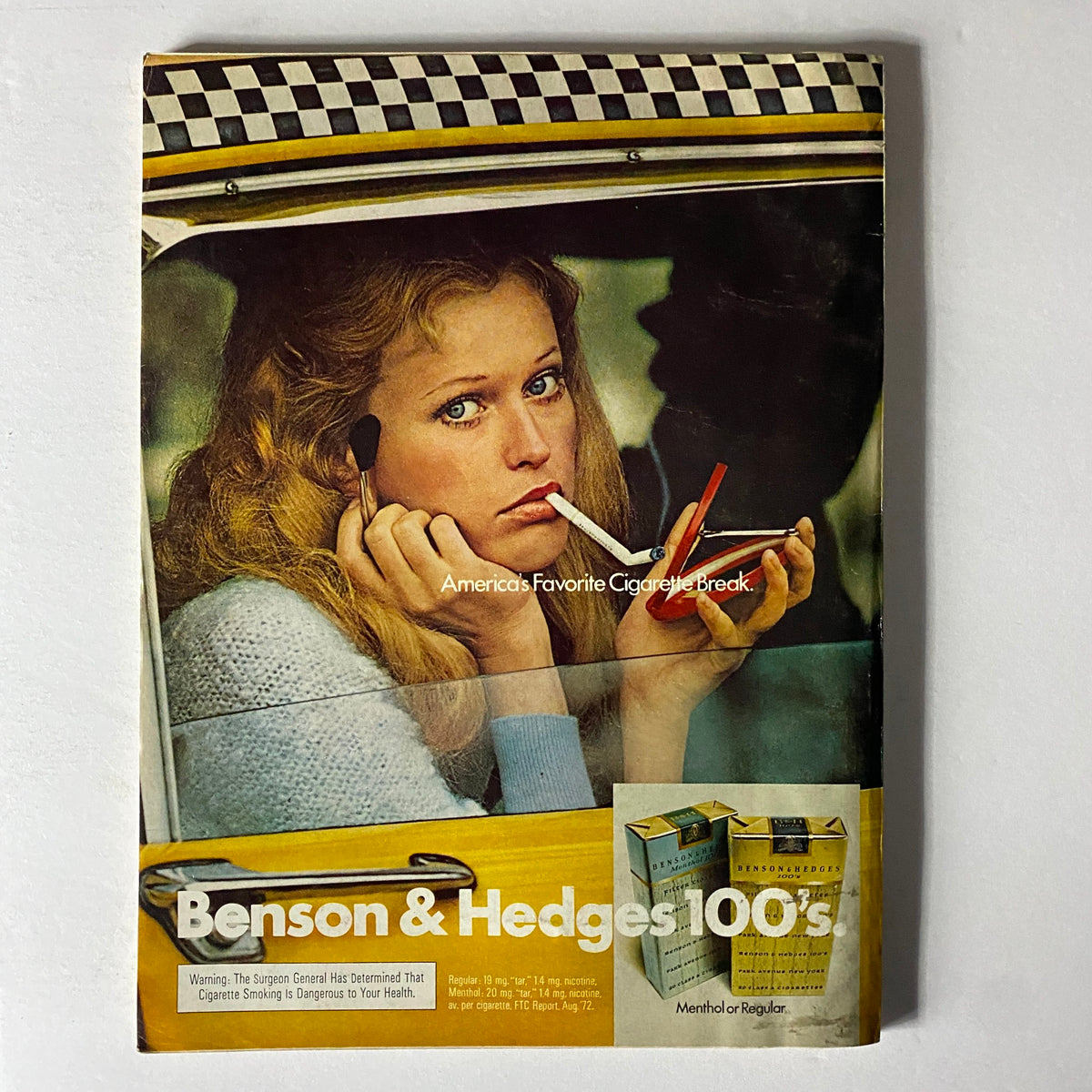 Vintage advertisement from Esquire Magazine February 1973 for Benson & Hedges cigarettes, featuring a woman in a car looking at the viewer.