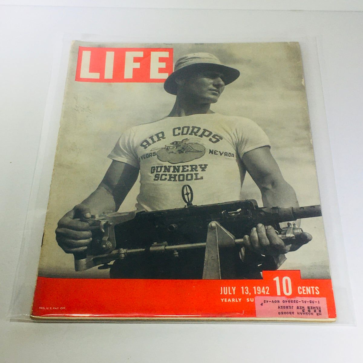 Cover of Vintage Life Magazine: July 13, 1942, featuring a soldier in a Air Corps Gunnery School t-shirt holding a firearm. This iconic magazine reflects World War II history and military training.
