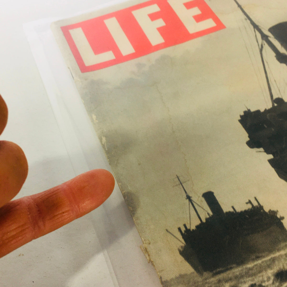 Detail shot of the cover of Vintage Life Magazine from July 27, 1942, highlighting the iconic Life logo and ships from the Atlantic Convoy.