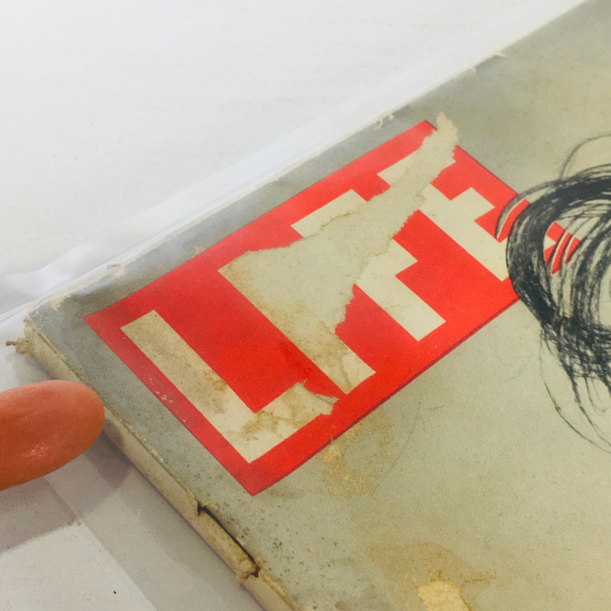 Detailed shot of the Vintage Life Magazine: Eye-Catcher cover, featuring the iconic red and white 'LIFE' logo with visible wear, indicative of its vintage charm from October 5, 1942.