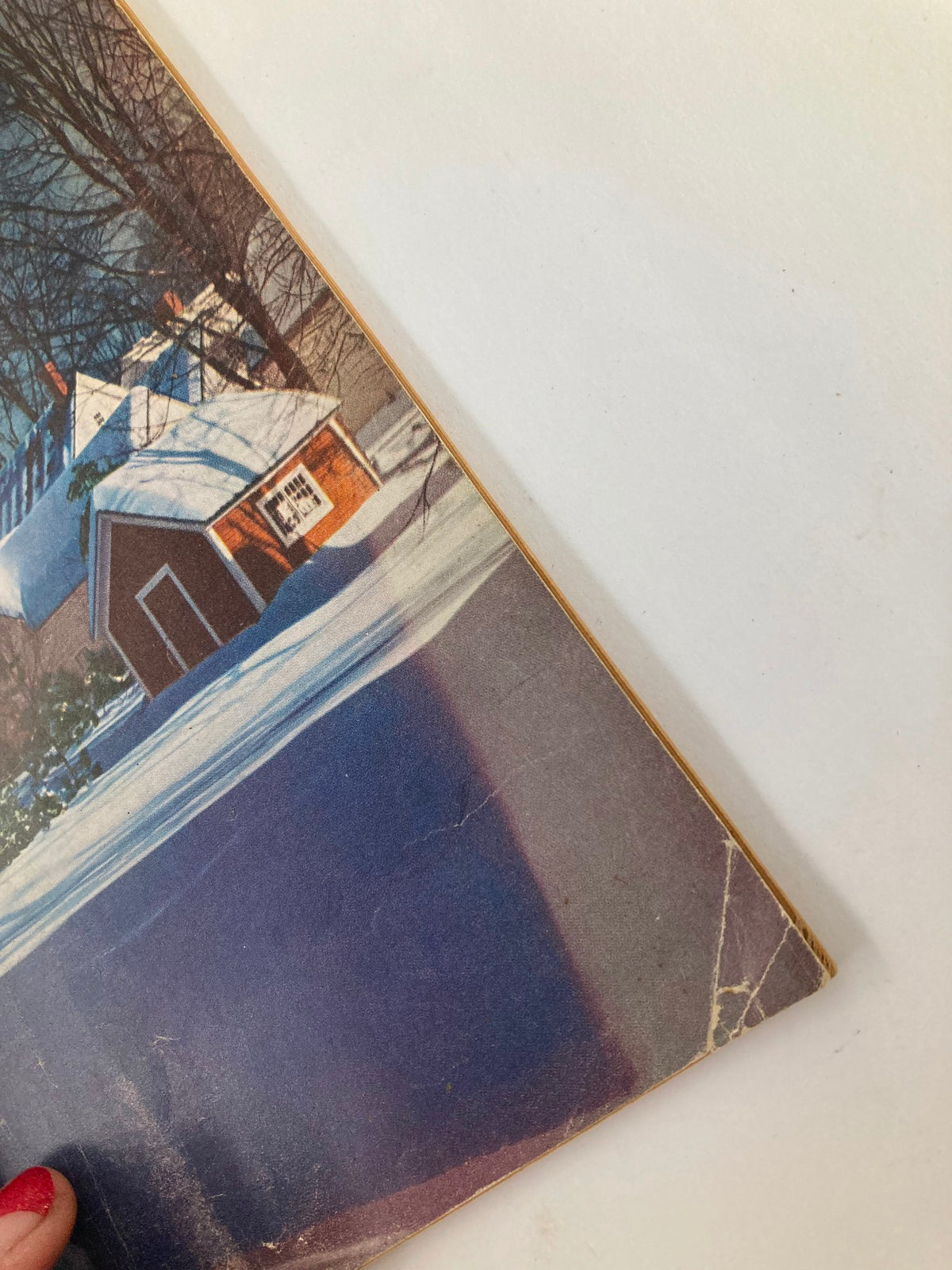 Close-up of the edge of the VTG Christian Herald Magazine January 1951, highlighting the vintage wear. The magazine features a beautiful snowy landscape and hints of age.