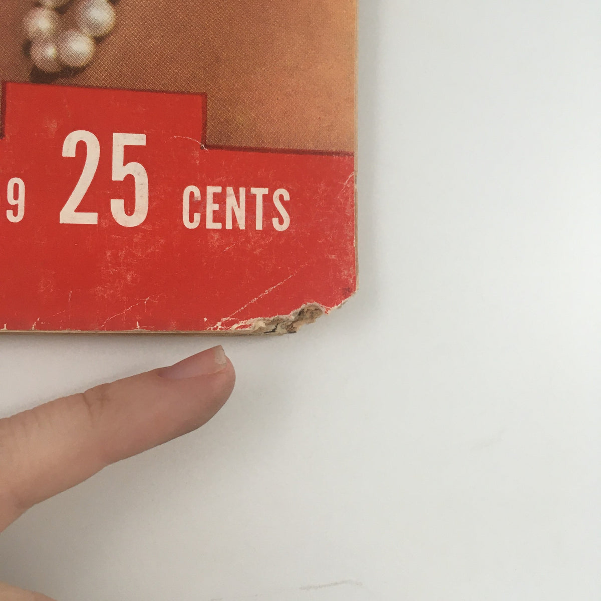 Close-up view of the price section of Life Magazine February 9, 1959 - The Saucy McLaines featuring the price of 25 cents and visible wear on the magazine cover.