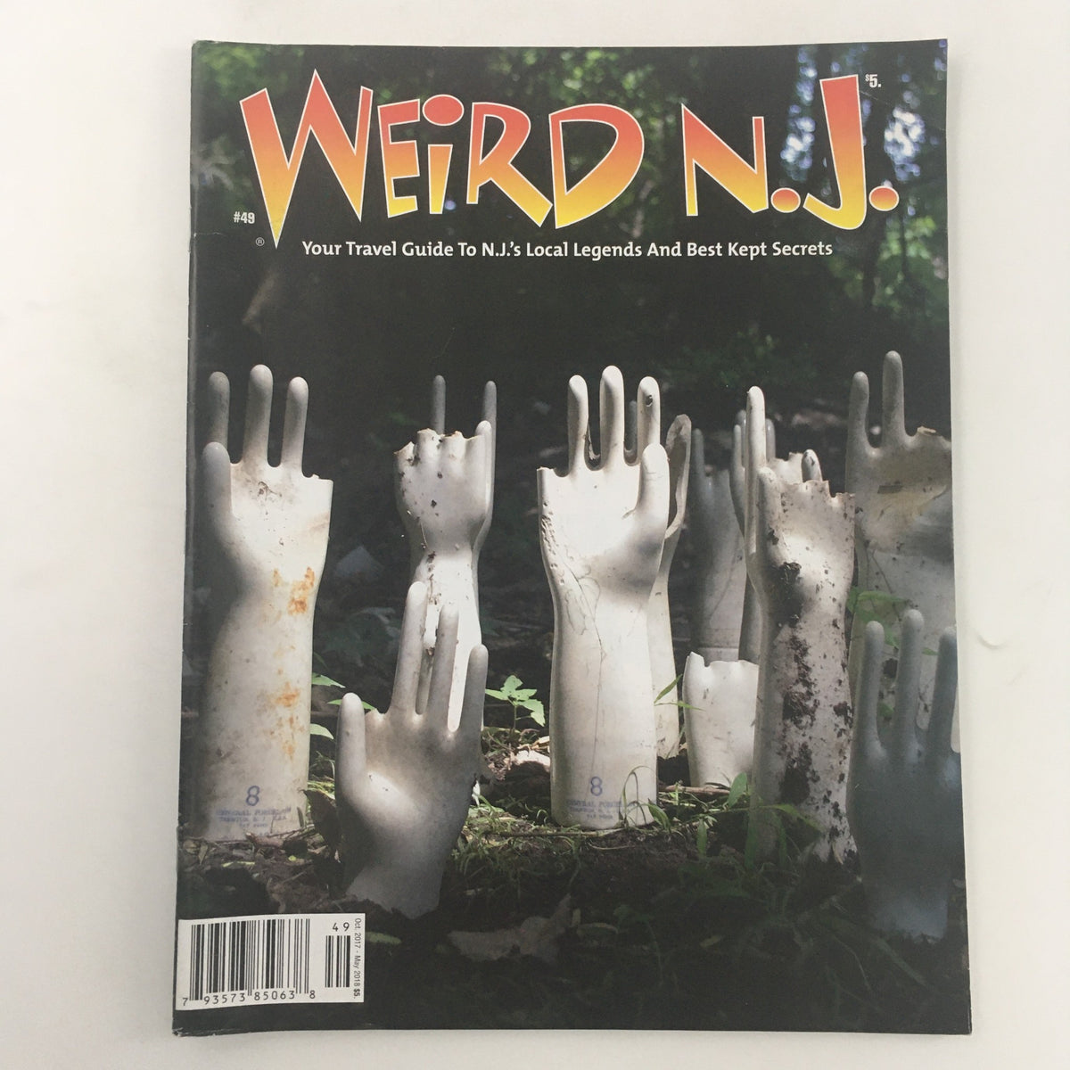 Weird N.J. Magazine October '17-May 2018 #49 cover featuring a unique and eerie scene of mannequin hands in a serene outdoor setting, emphasizing New Jersey's local legends and best kept secrets.
