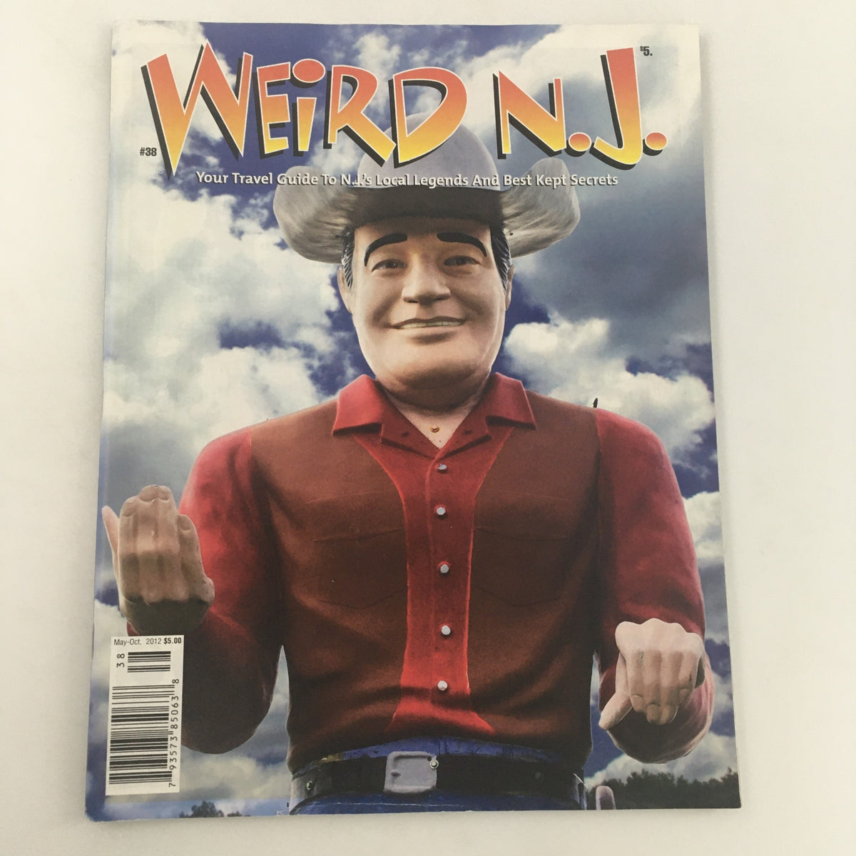 Cover of Weird N.J. Magazine, May-October 2012, Issue #38 featuring a large statue in a cowboy outfit, showcasing unique travel advice and cultural insights about New Jersey.