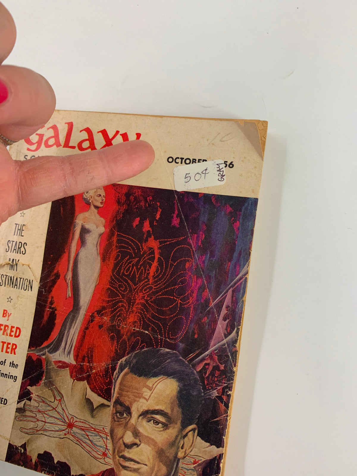 Close-up view of the Galaxy Science Fiction Magazine cover, October 1956, displaying the title 'The Stars in My Destination' by Alfred Bester. The image highlights a price sticker and features striking illustrations typical of 1950s science fiction magazines.