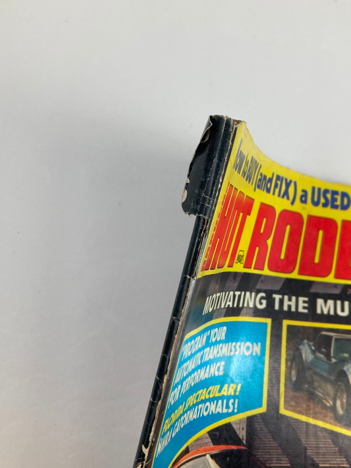 Close-up of the cover edge of VTG Popular Hot Rodding Magazine June 1974 Vol 13 #6, showing wear and tear.