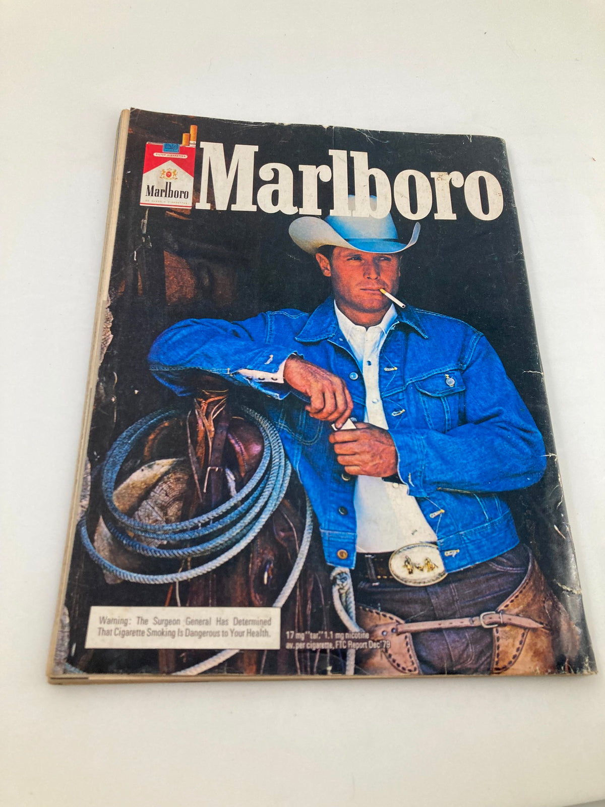 Cover of a vintage Marlboro advertisement featuring a cowboy model, representing Americana culture, laid beside the VTG Hot Rod Magazine May 1980 Vol 33 #5.