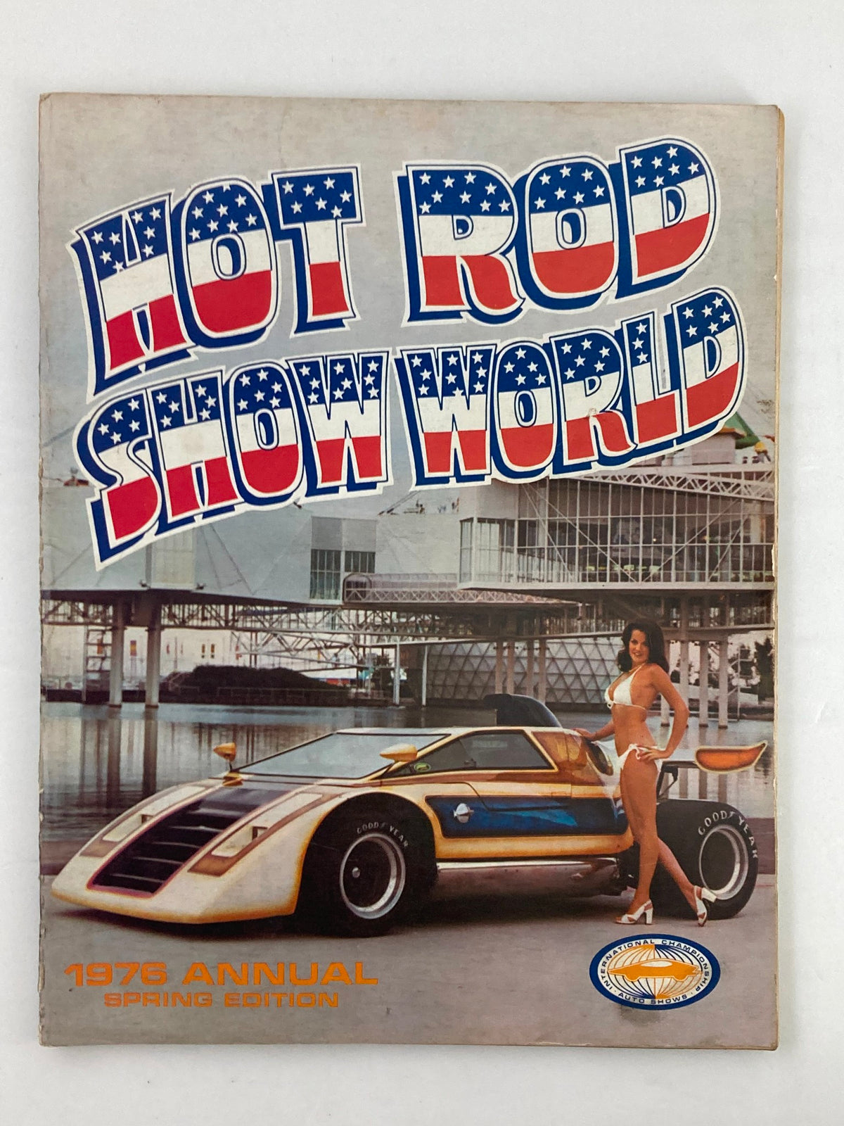 Cover of the 1976 Annual Spring Edition Hot Rod Showdown featuring a sleek car and a model, showcasing vibrant design and retro style.