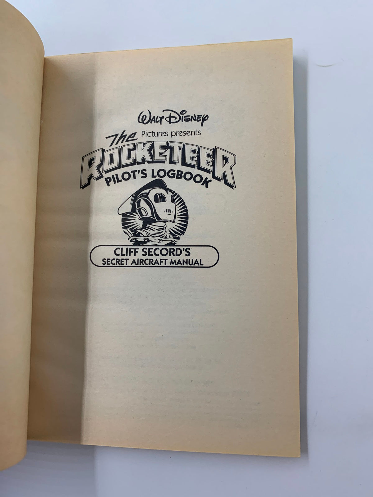 Inside title page of the Walt Disney The Rocketeer Pilot's Logbook Cliff Secord's Secret Aircraft Manual, showcasing the title and logo.