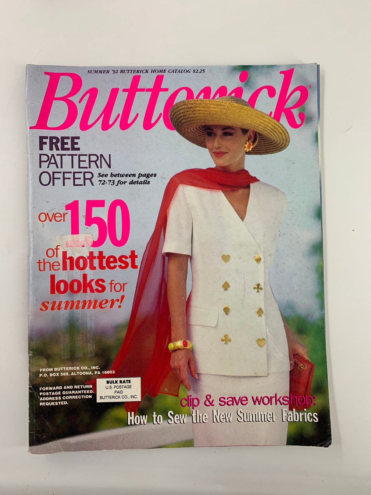 Cover of Butterick Magazine Summer 1992 featuring a model wearing a stylish white outfit and a large straw hat, showcasing summer fashion trends and sewing tips.