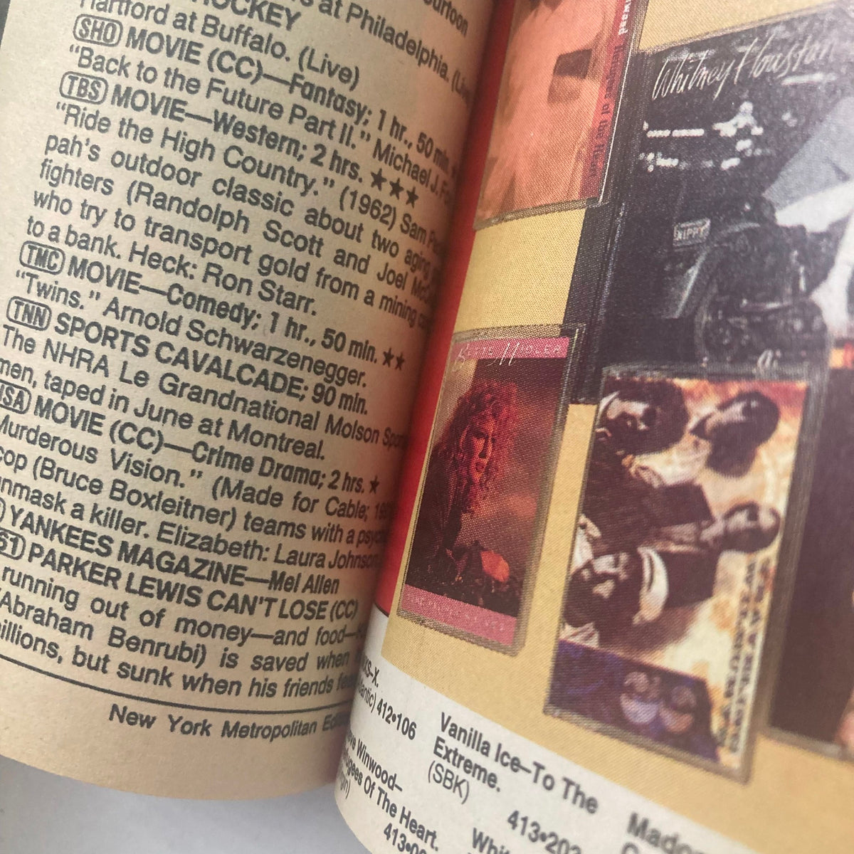 Inside view of TV Guide Magazine February 23 1991 showing TV listings and ads, featuring Roseanne Barr and Peter Arnett on the cover.