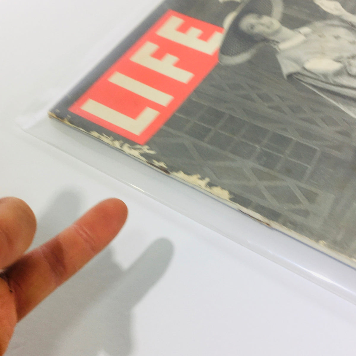 Side view of VTG Life Magazine, November 6, 1944, displaying the magazine's title and vintage art, with a hand in the foreground emphasizing its condition.