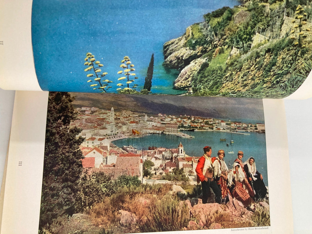 Breathtaking view of the Dalmatian coast with people in traditional dress, illustrated in the January 1928 issue of The National Geographic Magazine, showcasing Dalmatian Days.