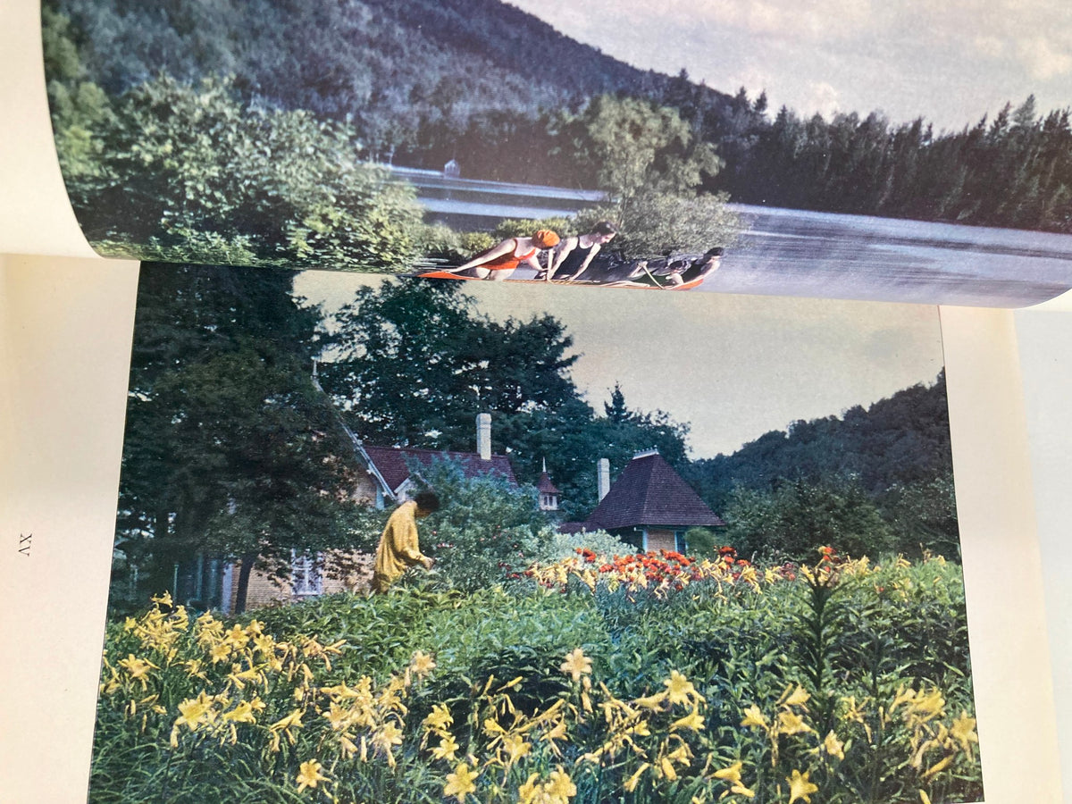 Vintage National Geographic Magazine March 1927 photo capturing a serene scene with people enjoying recreational activities by a lake surrounded by lush greenery.