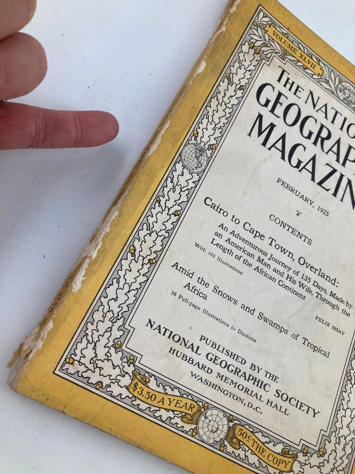 Close-up of the spine of the February 1925 National Geographic Magazine showing wear and the title contents.